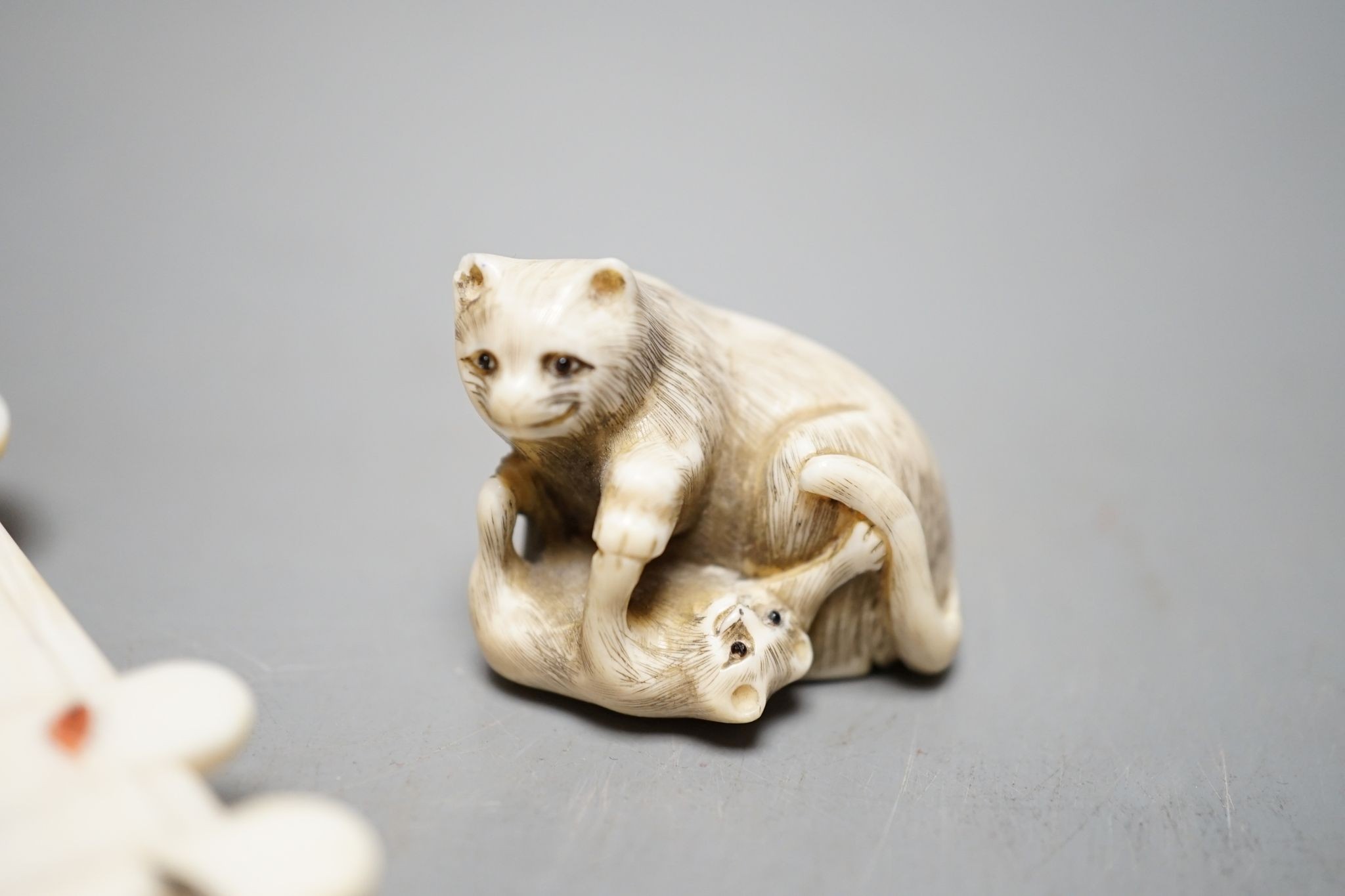 A 19th century ivory netsuke cat group and a Meij period ivory shibayama bezique marker, 9cm.